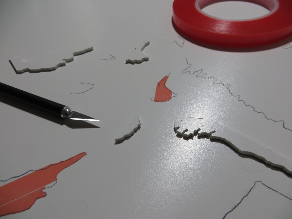 The pumpkin plate has a lot of free floating pieces. I'm using double-sided tape to hold the pieces in place so that I can remove them if I need to make adjustments to the edge contours. In this picture I am trimming the tape so that it doesn't extend into the non-printing area and possibly stick to the paper.