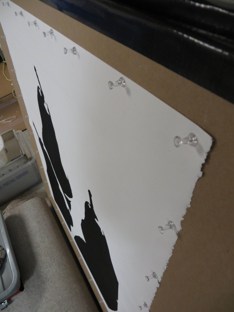 I'm trying a new method of drying that flattens the print without disturbing the ink and the embossing. The wet print is pinned to a piece of sheetrock using push pins spaced every three inches.