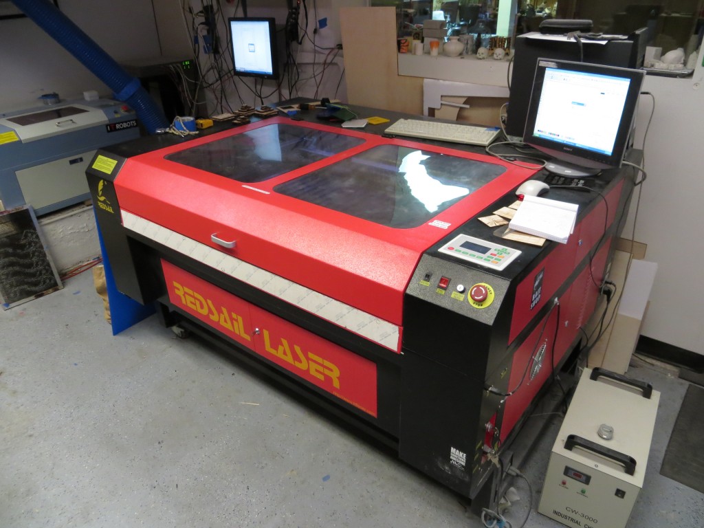 This monster is a 100W Full Sale laser cutter. It handles material up to 32" x 45". Cuts acrylic and wood like butter at about 1000 dpi.