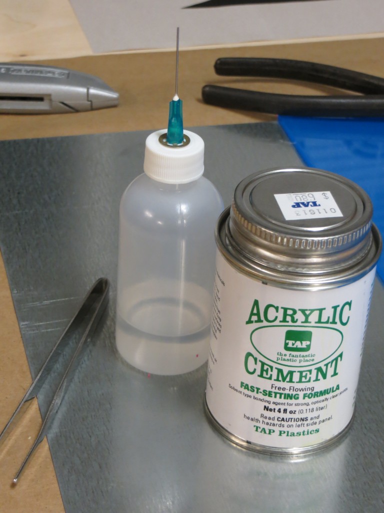 I am using acrylic cement from TAP Plastics to assemble the plate. The syringe bottle shown on the left is a huge help in spreading the cement and containing the fumes. The great thing about the syringe is that you can run it along the joints and they will draw in the cement through capillary action.