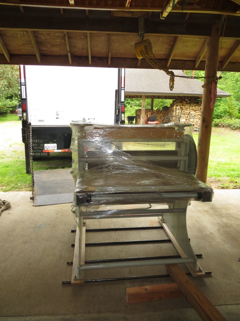 We used four pieces of 3/4" steel gas pipe as rollers to move the press out of its old home. The rollers worked really well when moving the press straight ahead. Turns were another story altogether. We used an eight foot long 4x4 as a pry bar to rotate the press a few degrees at a time.